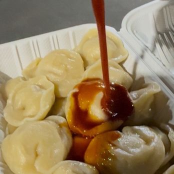 Pelmeshki - Pouring the spicy shoyu sauce - Food Trucks Near Me - Aiea, Hawaii