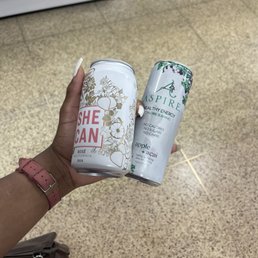 a person holding a can of she ban
