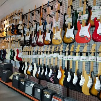 Eco Town - Wall of Guitars! Various amps on bottom - Used, Vintage & Consignment Near Me - Honolulu, Hawaii Eco Town - Wall of Guitars! Various amps on bottom - Used, Vintage & Consignment Near Me - Honolulu, Hawaii