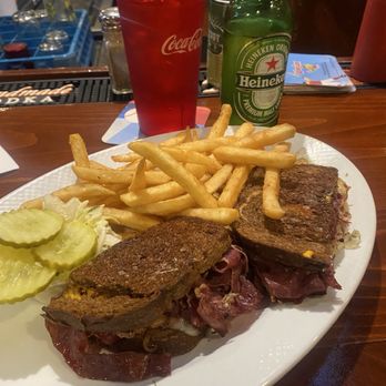 Morse Tavern - Pastrami sandwich with fries and Cole slaw was good. - A meal featuring French dip sandwiches with French fries and pickles, accompanied by a Heineken beer and a Coca-Cola drink at a bar. - Irish Near Me - Natick, Massachusetts