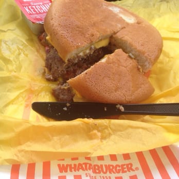 Whataburger - a half eaten sandwich with a knife - Fast Food Near Me - Ruston, Louisiana