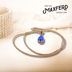 Maxferd Jewelry & Loan - Elegance in full bloom! Adorn yourself with the exquisite 14k Gold Tanzanite & G.I.A, certified sapphire necklace.