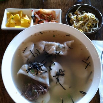 Mokja - $12.95 Dduk Mandoo Guk: rice cake, pork scallion dumplings in mild peppery beef broth. Yam noodle hidden at bottom! No egg. - Korean Near Me - Astoria, New York Mokja - $12.95 Dduk Mandoo Guk: rice cake, pork scallion dumplings in mild peppery beef broth. Yam noodle hidden at bottom! No egg. - Korean Near Me - Astoria, New York