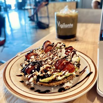 Vigilante Coffee - The GOAT toast (asked to add balsamic drizzle on top) and an iced vanilla latte - Coffee & Tea Near Me - Oceanside, California Vigilante Coffee - The GOAT toast (asked to add balsamic drizzle on top) and an iced vanilla latte - Coffee & Tea Near Me - Oceanside, California