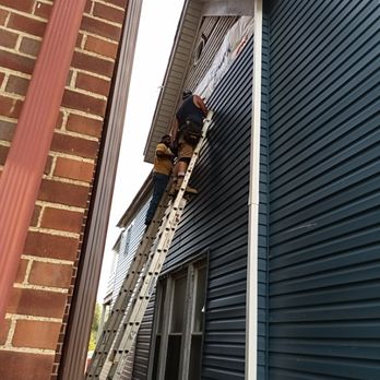 G D Construction - a man on a ladder on a house - General Contractors Near Me G D Construction - a man on a ladder on a house - General Contractors Near Me