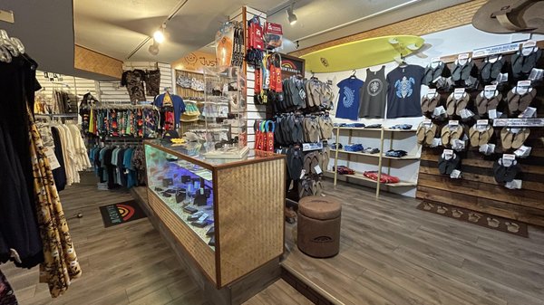 Men's Apparel - The latest and fashionable designed apparel for men and young men. There is always something new coming to the store, so come  on down and see what's here for you/him. Whether it's shorts, shirts, wallets, shades or any other beach/ surf merchandise and accessory we have you covered. Stop by and say hi. Many Mahalos!!