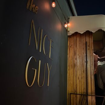 The Nice Guy - a man standing outside of a restaurant - Italian Near Me - Los Angeles, California