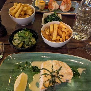Seaside - Halibut, seaside friends and cucumber salad in the foreground, prawns, fries and quilted lettuce in the background.  Delicious! - Seafood Near Me - Berlin, BE