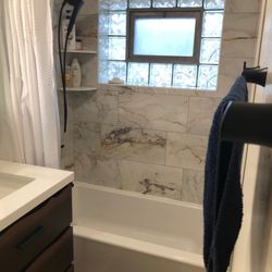 Fox Home Center - Vanity, mirror, towel bar, hook, and the shower/tub faucets from Fox Home Center.