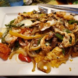 Especially Nayariti - beef, chicken and shrimp fajitas on top of rice with tomatoes and a cheesy sauce. Yum. Especially Nayariti - beef, chicken and shrimp fajitas on top of rice with tomatoes and a cheesy sauce. Yum.