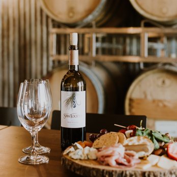 Sawtooth Winery - a wine bottle and a plate of food - Wineries Near Me - Caldwell, Idaho