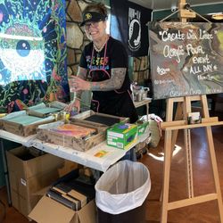 Create With Lisee - A picture of me demonstrating an acrylic pour, at an all day event