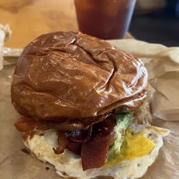 Coffee and breakfast Egg Sandwich with Cheddar and avocado