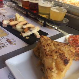 Beer sampler, cheese plate, and tortilla española