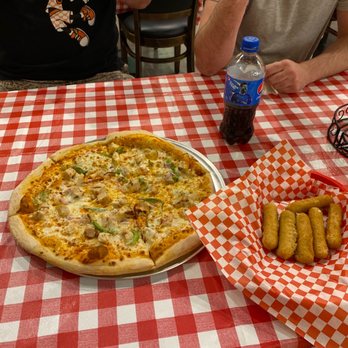 Bella Cafe - a pizza on a table - Desserts Near Me - Frisco, Texas