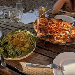 Pepperoni pizza and Caesar salad Pepperoni pizza and Caesar salad