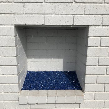 American Chimney Sweep - Blue fire glass in an outside fireplace - Chimney Sweeps Near Me
