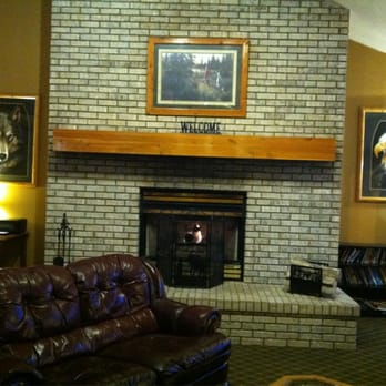 AmericInn by Wyndham Rhinelander - Lobby with comfy leather sofas and fireplace - Hotels Near Me - Rhinelander, Wisconsin