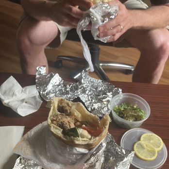Pitago Mediterranean Fresh - Inside my Gyro Wrap, a peek at Mr R's Dolma, and you can see Mr R holding a Falafel Wrap for scale. 01AUG26 - Mediterranean Near Me - San Marcos, Texas