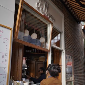 Fellini Coffee - a woman looking out the window - Coffee & Tea Near Me - New York, New York Fellini Coffee - a woman looking out the window - Coffee & Tea Near Me - New York, New York