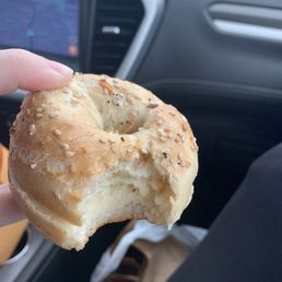 a person holding a hot bagel a person holding a hot bagel
