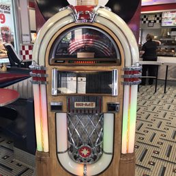 a juke box with a clock on top
