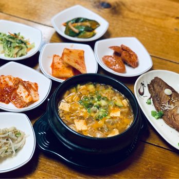 Gomonae - a variety of dishes of food on a wooden table - Korean Near Me - Dallas, Texas Gomonae - a variety of dishes of food on a wooden table - Korean Near Me - Dallas, Texas