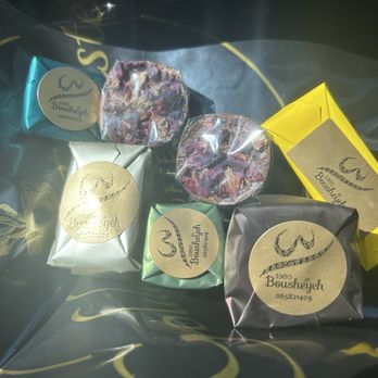 Golden Roastery - Individually wrapped chocolates including rose, pistachio cream, coconut, brownie cupcake, and peanut. - Coffee Roasteries Near Me - Houston, Texas