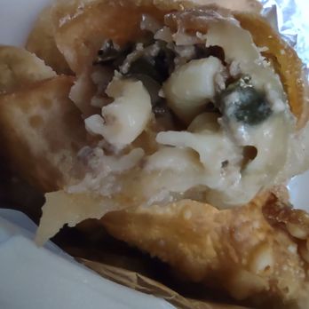 Mr A Ok's Kitchen - Close up of the inside of the roll showing 5he mac & cheese, ground beef, greens in a wonton wrapper. - Soul Food Near Me - San Antonio, Texas
