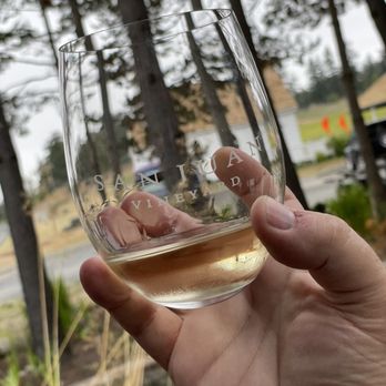 San Juan Vineyard - a hand holding a glass of wine - Wineries Near Me - Friday Harbor, Washington