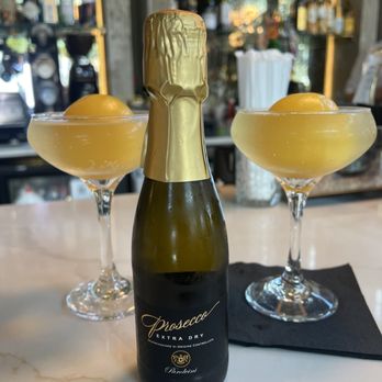 Mangoni - Mimosa with frozen orange juice ball. - Pizza Near Me - Winter Garden, Florida