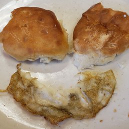 Overly microwaved and too hard to eat biscuits and cold eggs covered in dirty grease. Overly microwaved and too hard to eat biscuits and cold eggs covered in dirty grease.