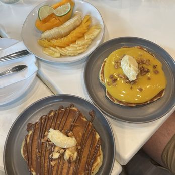 Break + Feast - Banana pancake and lilikoi pancake with a fruit plate - Breakfast & Brunch Near Me - Koloa, Hawaii