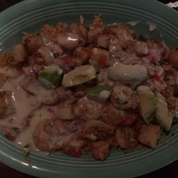 Los Cabos. scallops crawfish and shrimp over rice in a cheese sauce! Avacado garnish ....ps the picture does it no justice !