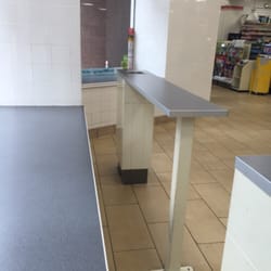 7-Eleven - Tables for people to eat/stand/sit on