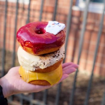 Fan-Fan Doughnuts - a hand holding a stack of donuts - Donuts Near Me - Brooklyn, New York Fan-Fan Doughnuts - a hand holding a stack of donuts - Donuts Near Me - Brooklyn, New York