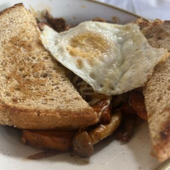 Everly - Sirloin Hash - A dish featuring toasted bread, a fried egg, and sautéed vegetables, served on a white plate with a gold rim. - New American Near Me - Madison, Wisconsin