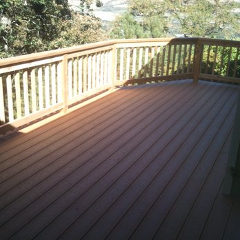 Arruda Built Construction - a wooden deck with railings - General Contractors Near Me