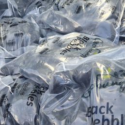 22 bags of large polished black pebbles