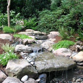 LandArts Landscaping - The movement and sound of water provides a great focal point in the garden without the maintenance a pond requires. - Landscaping Near Me - Apex, North Carolina LandArts Landscaping - The movement and sound of water provides a great focal point in the garden without the maintenance a pond requires. - Landscaping Near Me - Apex, North Carolina