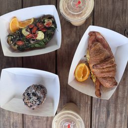 Iced vanilla latte, blueberry muffin, breakfast croissant, and vegan pain fromage Iced vanilla latte, blueberry muffin, breakfast croissant, and vegan pain fromage