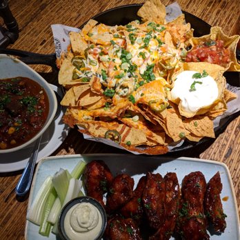 Banff Ave Brewing Co - Nachos with a side of bison chili, sweet so yummy and lemongrass chicken wings - Breweries Near Me - Banff, Alberta