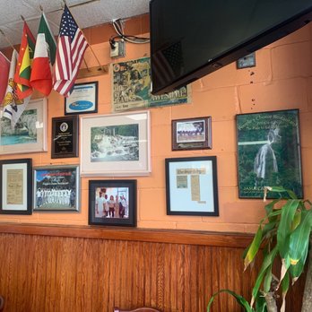 People's Choice Restaurant - a wall of flags and pictures - Caribbean Near Me - East Orange, New Jersey