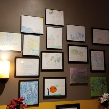 Astin J's - a wall of framed art - Tacos Near Me - Groton, Connecticut