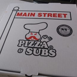 a pizza box on a table a pizza box on a table