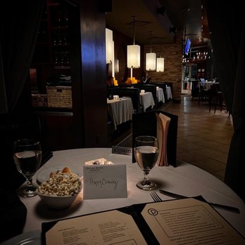 Ocean Prime - a table with a menu and a bowl of popcorn - Seafood Near Me - Orlando, Florida