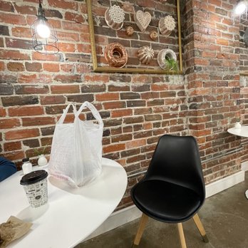 Scratch Bakery - a brick wall and two chairs - Bakeries Near Me - Hampton, Virginia