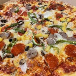 A supreme 16" pizza with olives on the side and pineapple on top (extra $3)