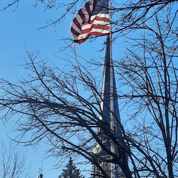 Market 32 By Price Chopper - a church steeple with an american flag in the foreground - Grocery Near Me - Guilderland, New York Market 32 By Price Chopper - a church steeple with an american flag in the foreground - Grocery Near Me - Guilderland, New York