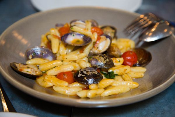 Photo of Delfina - San Francisco, CA, US. pasta with clams and cherry tomatoes